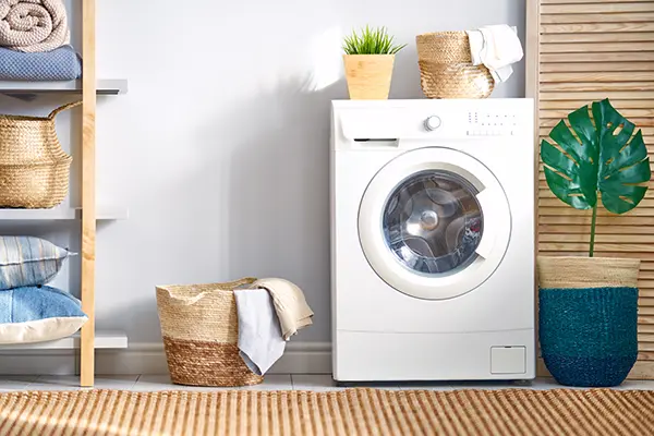 Washing machine in laundry room with bright modern decor